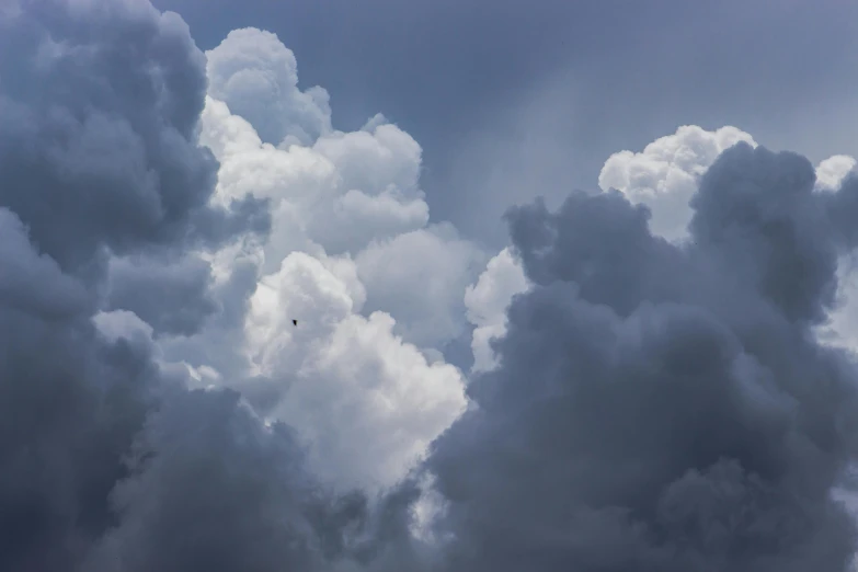 a cloudy sky with a large jet flying by