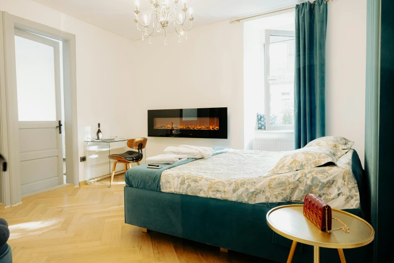 a room with wood floors and a chandelier