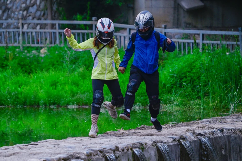 two people in protective gear running on a wall