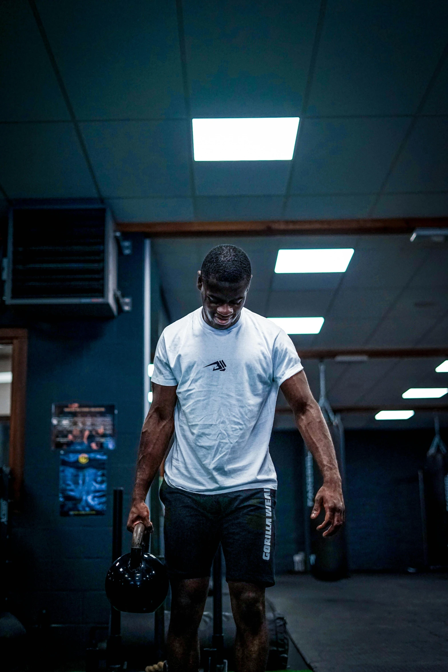 a man with his legs crossed and weights in hand