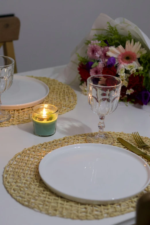 the place setting with candles in between the plates