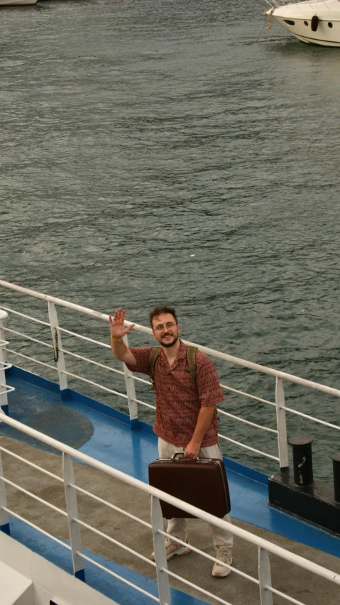 man on cruise ship waving at the camera