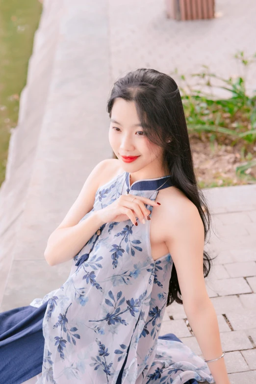 a beautiful asian woman wearing a long dress and posing