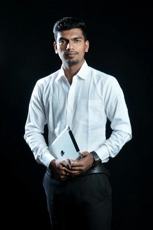 a man with white shirt and black pants holding a folder