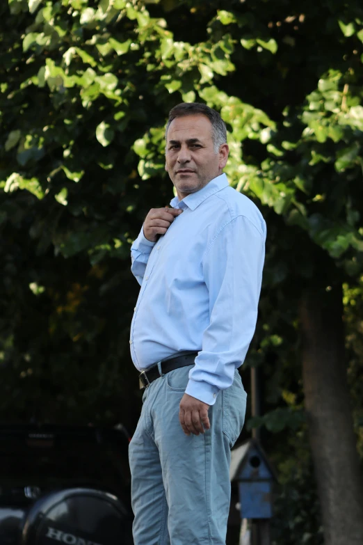 a man is standing outside and wearing a shirt