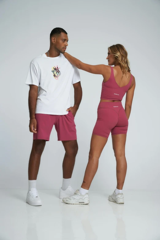 man and woman in matching outfits looking at each other