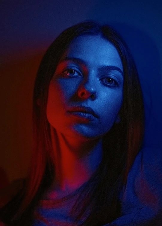 a woman looks over her shoulder in the dark