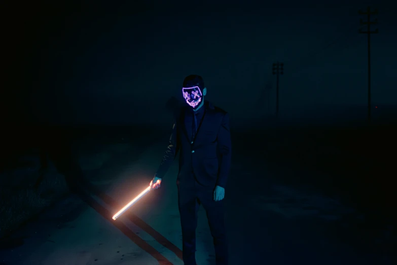 the man is wearing a neon mask and holding a flashlight