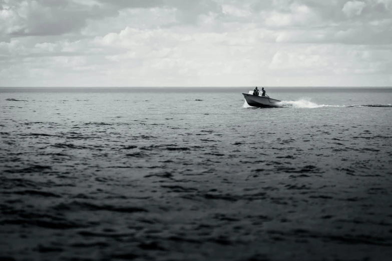 black and white pograph of a boat on the ocean