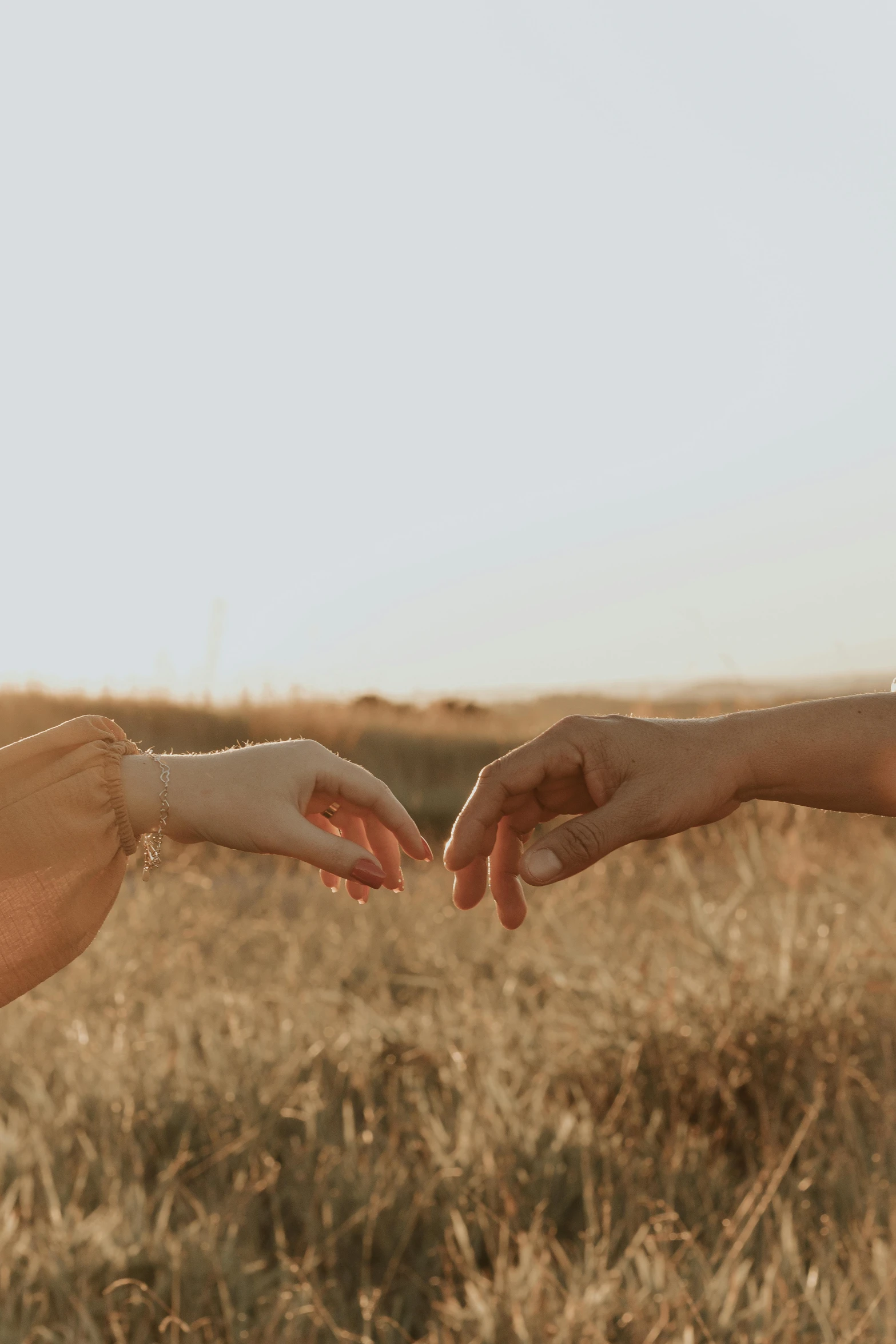 a man and a woman reaching out to touch hands