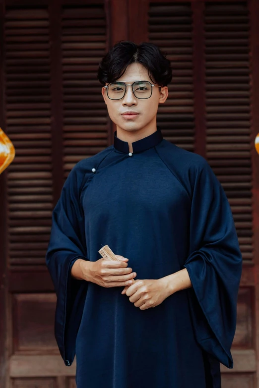 a man in dark blue clothing and some hanging lanterns