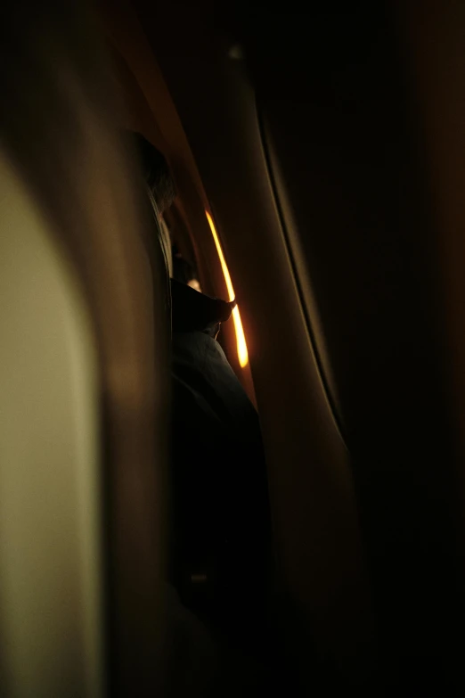 view of light through airplane window in dark