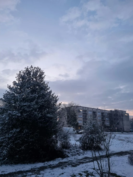 a snowy landscape with a tall tower in the distance