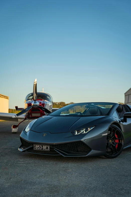 a silver sports car parked on a runway