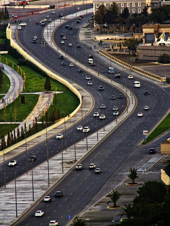 multiple lanes of traffic travel along an asphalt road