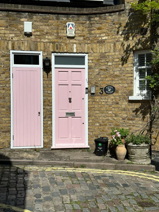 there are two pots and one door that is painted pink