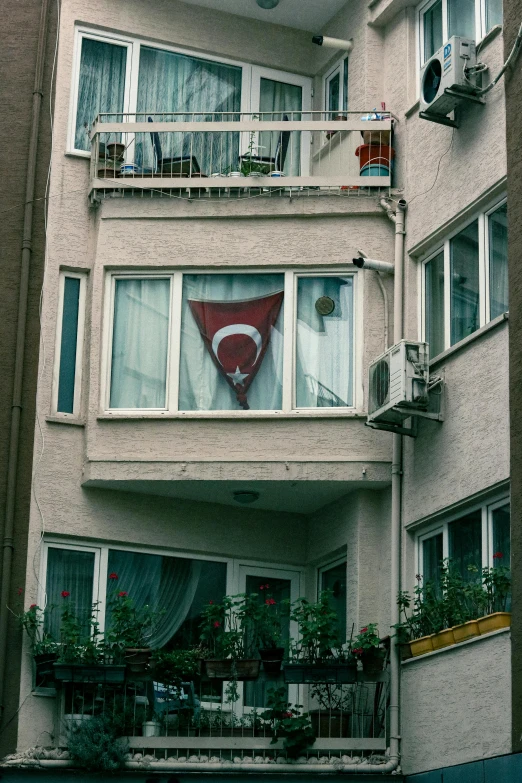 a building with balconies and a giant teddy bear on the balconies