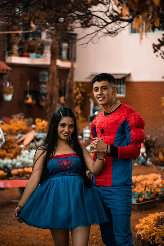 two people dressed up in spider man costumes