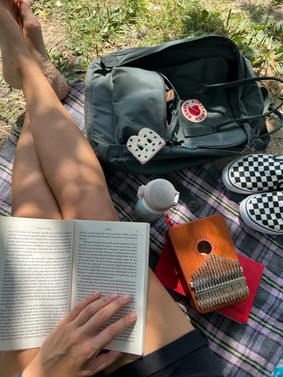 someone is laying down and reading some books