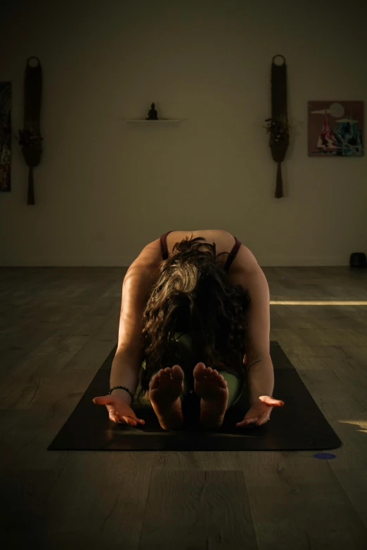 a person with their head down in a yoga position