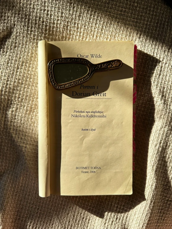 a brown leather book laying on top of a piece of paper