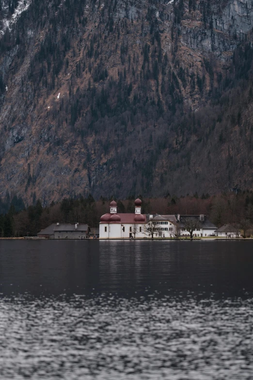 there is a house on a small island in the middle of water