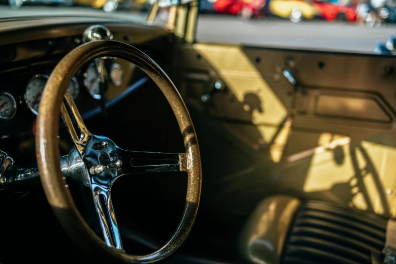 the interior of an old classic car with some brown steering wheels