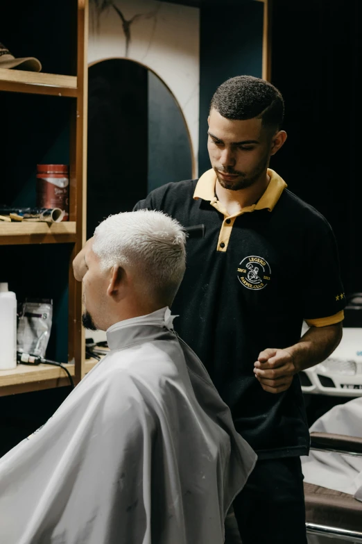 a man getting his hair cut by a barber