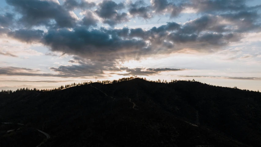 the sky is darkened by dark clouds at sunset