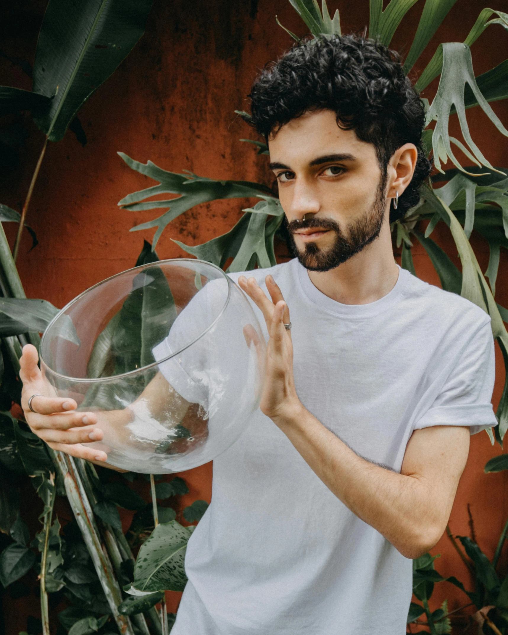 a man with a large vase holds soing in his hands