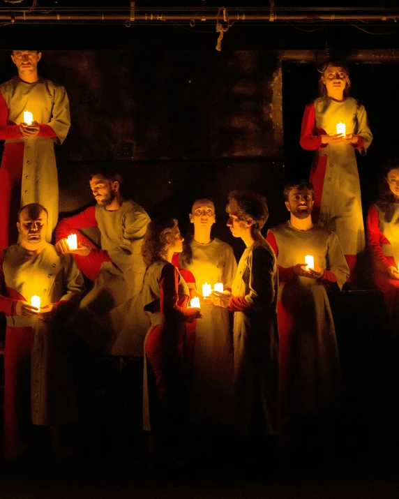 candles burn as priests carry to the altar