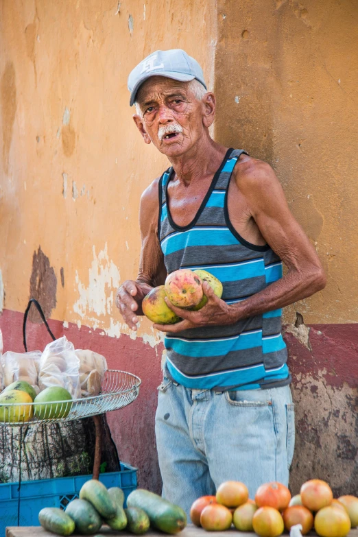 a man holding fruit and making face next to the street