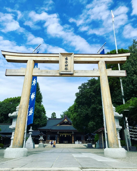 large and ornate wooden gate with flags at entrance