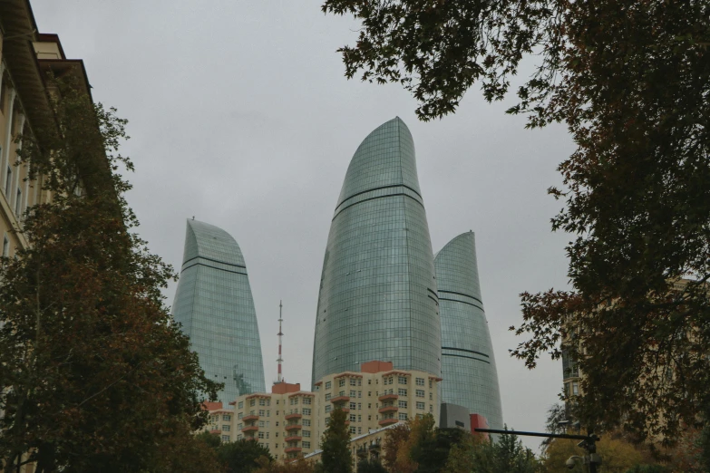 a view of buildings near the trees in the rain
