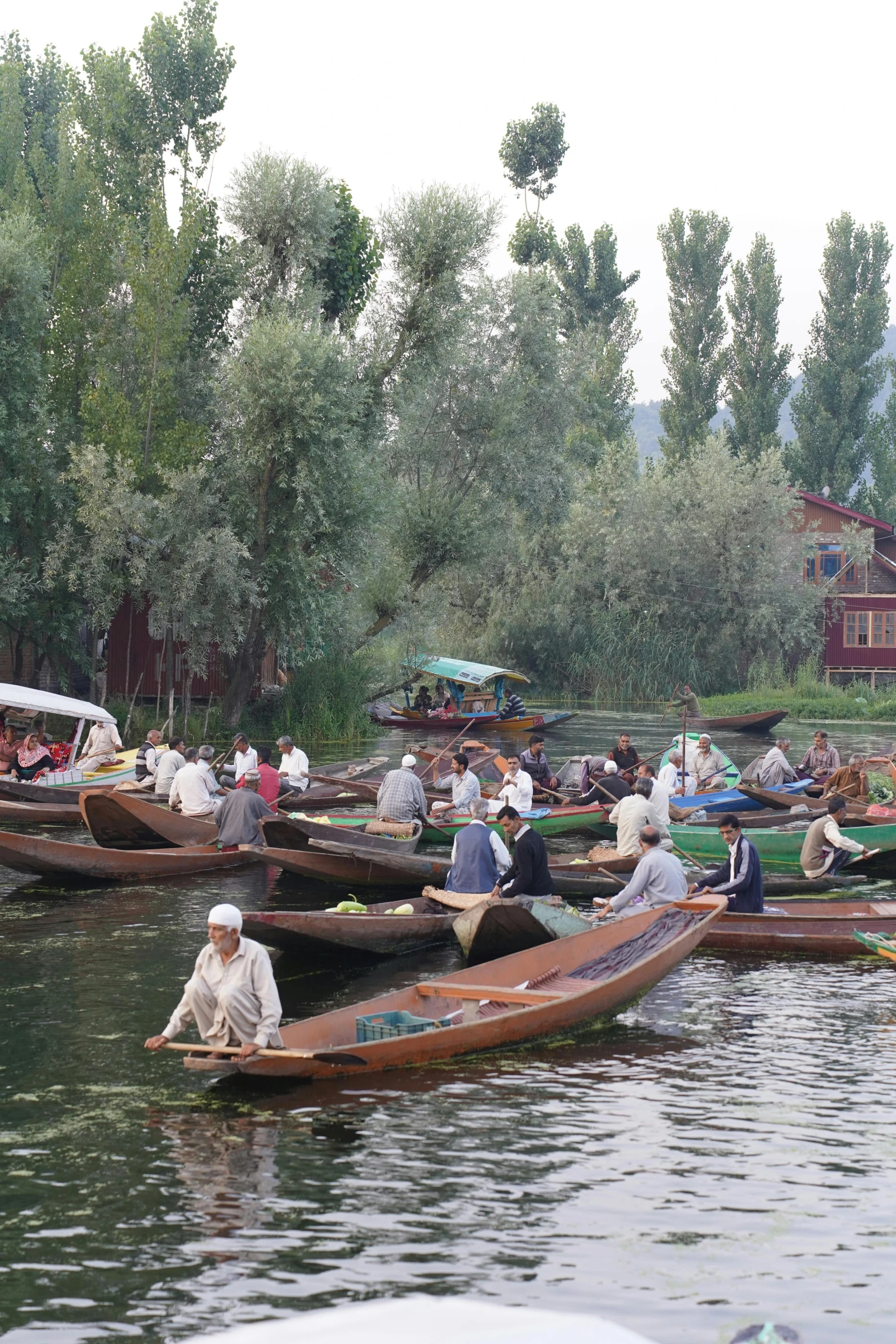 a group of people on small wooden boats on a river