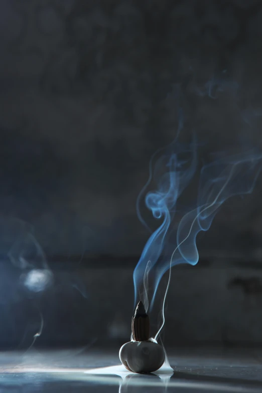 an apple covered in blue smoke sitting on a table