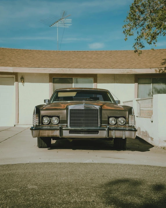 a car parked outside a house with a tall roof