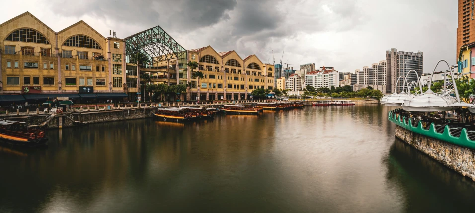 boats are lined up on the water near buildings