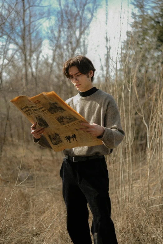 young man holding a piece of wood outside