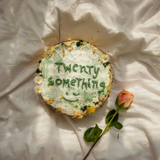 a cake and flower are laying on the sheet