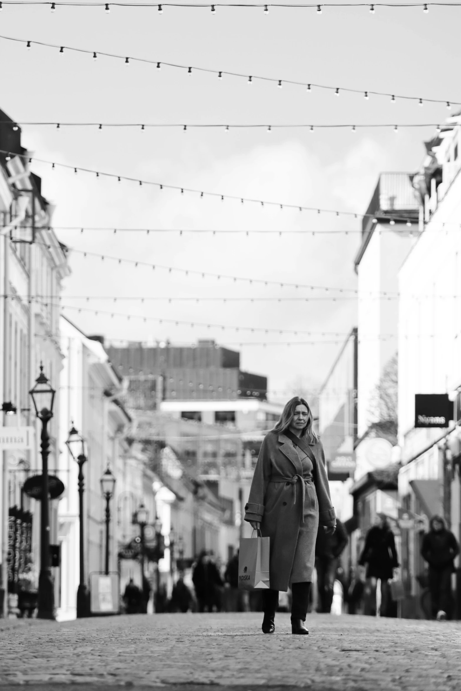 a woman walking down the street during winter