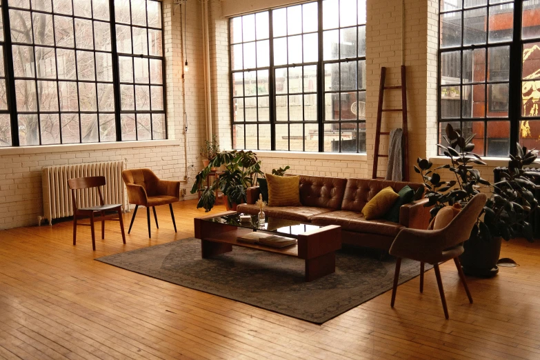 a living room is shown with wood floors and lots of windows