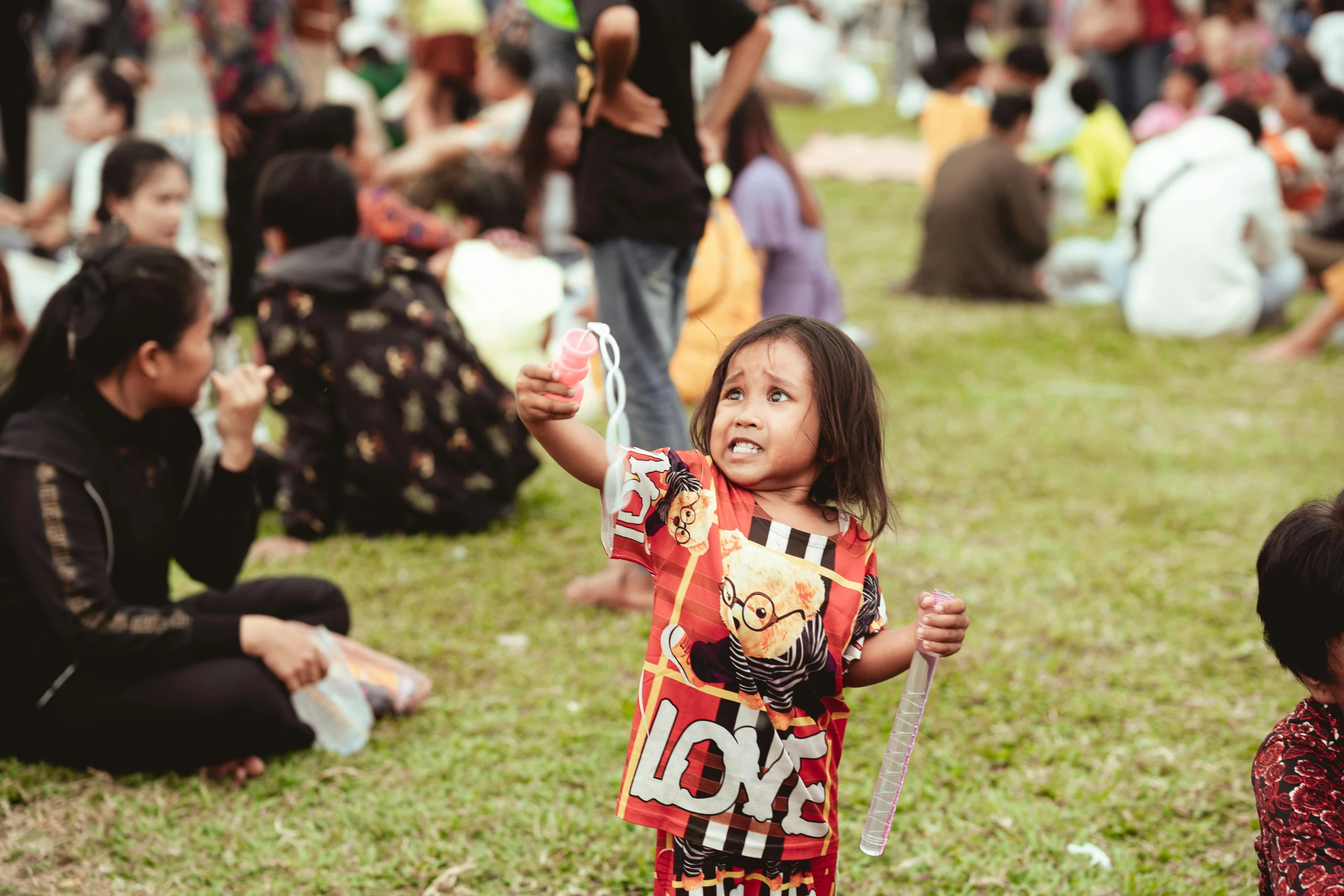 a girl holding onto an object in the air