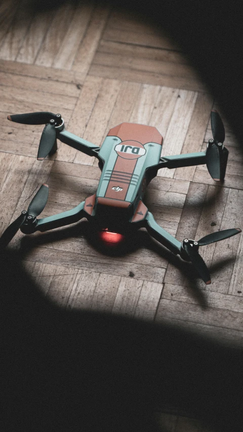 a close up s of a remote control system on a wooden floor