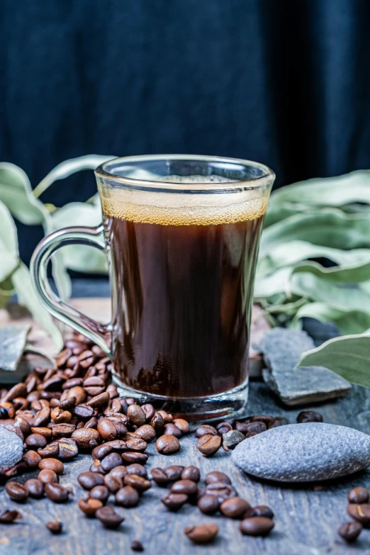 a cup of coffee sitting on top of a wooden table