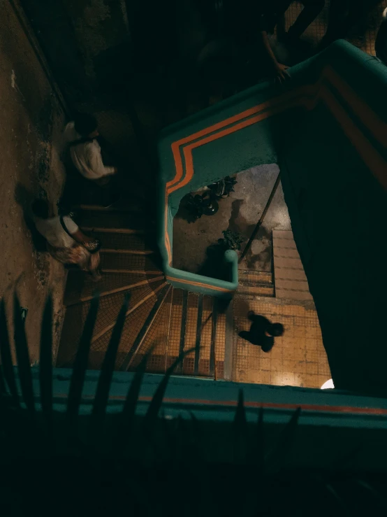 a dark scene with the shadow of a person going down stairs