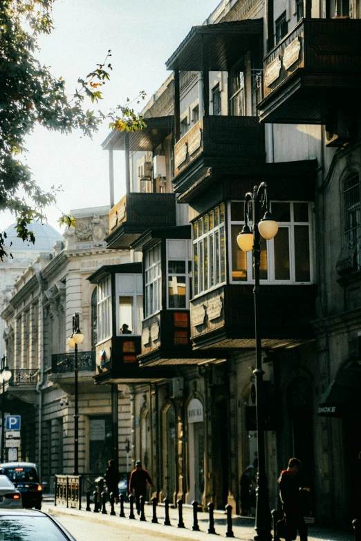 many people are walking along a city street