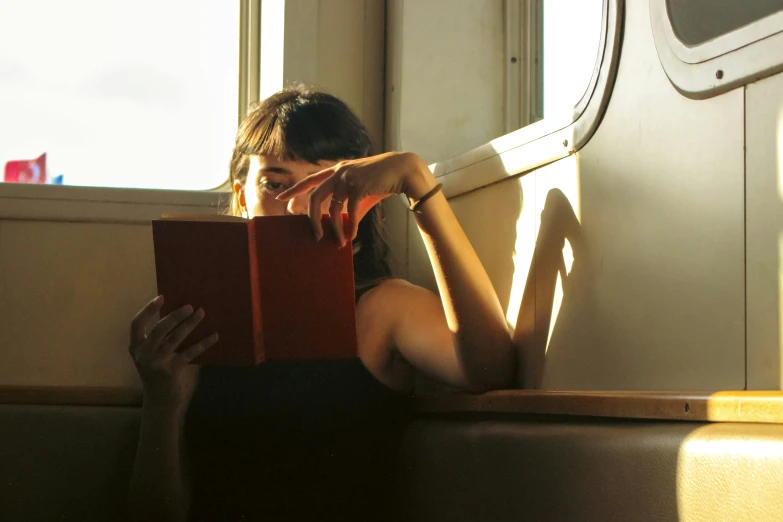 a young woman sitting down in a train car