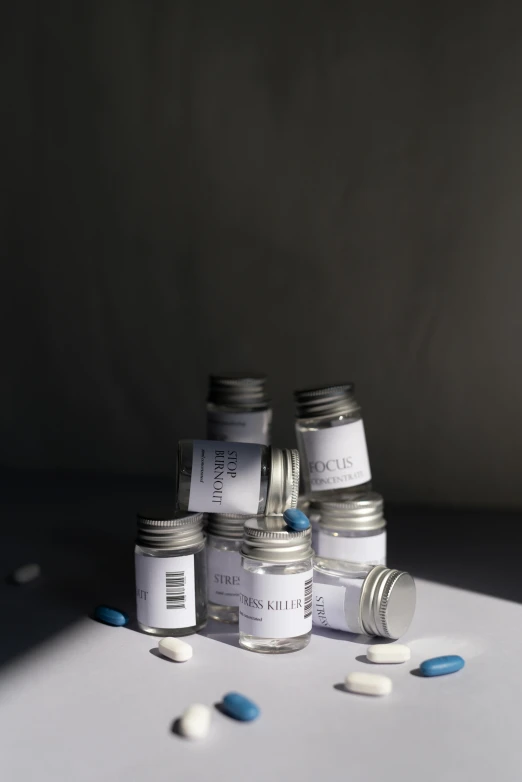 some pills sit next to a group of jars