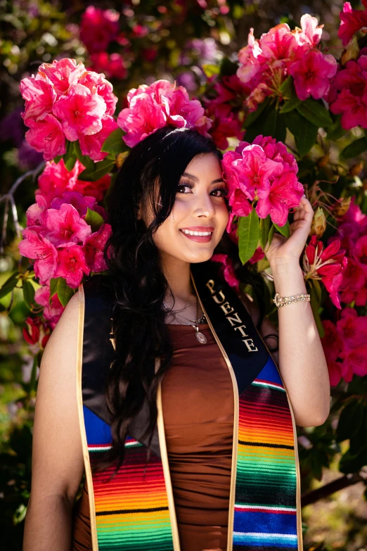 young woman with flowers in her hair standing on the grass